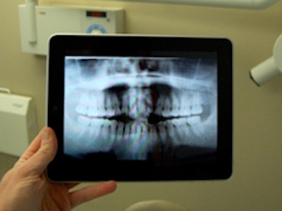 Mark Burhenne, D.D.S., uses his iPad to show patients digital radiographs of their teeth. Image courtesy of Dr. Mark Burhenne.