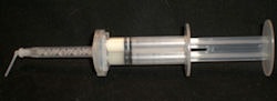 Figures 3 and 4: Top, loading the Mojo syringe. Bottom, Mojo syringe loaded with unmixed catalyst and base. Note extended tip for easy access to preps or post canals.