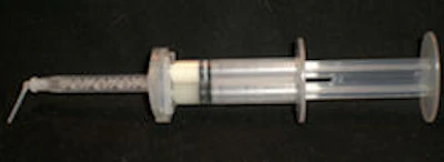 Figures 3 and 4: Top, loading the Mojo syringe. Bottom, Mojo syringe loaded with unmixed catalyst and base. Note extended tip for easy access to preps or post canals.