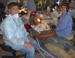 David Maahs, DDS, and dental assistant Qian 'Jenny' Zhuang provide care to Daniel Cruz.