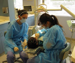 University of California, Los Angeles dental students Shahrzad Morim (left) and Stephanie Lee (right) provide care at the Children's Dental Center of Greater Los Angeles.