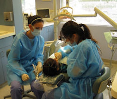 University of California, Los Angeles dental students Shahrzad Morim (left) and Stephanie Lee (right) provide care at the Children's Dental Center of Greater Los Angeles.
