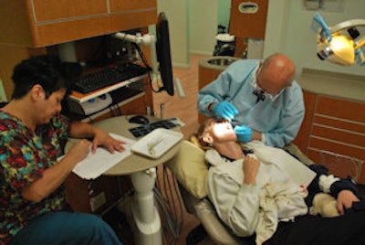 Melvyn Glick, DDS, examines Christina Grisham. Image courtesy of Jeff Crider.