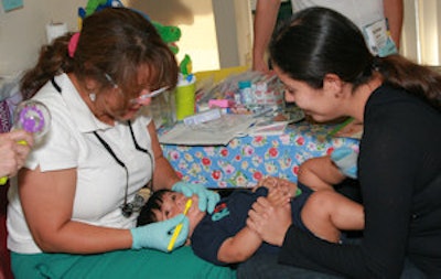 Debbie Hartman, RDHAP, does a toothbrush cleaning at a WIC center in Pomona, CA. Image courtesy of Center for Oral Health.