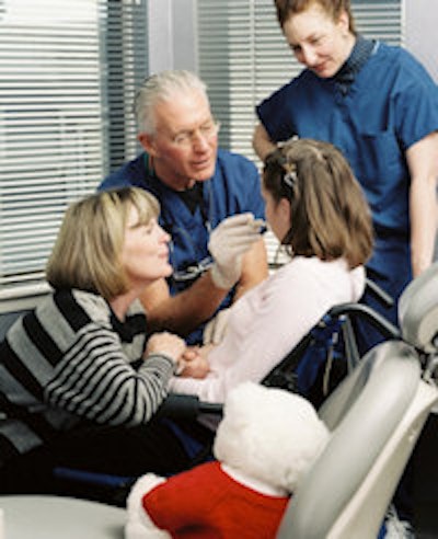 Dr. Blende and a staff member work on a special needs patient while she is being comforted by her mother. All images courtesy of Blende Dental Group.