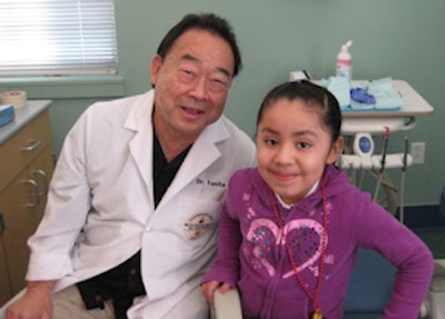 Daniel Tanita, DDS, and 6-year-old Guadalupe of Richmond, CA, during her first visit to the full-service clinic at Peres Elementary School.