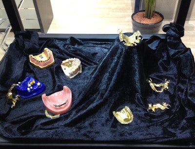 A display of gold partial dentures at IDS 2013.