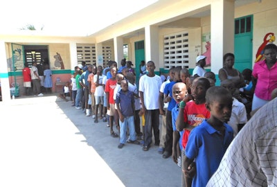 Children lining up to see the dentists at a large orphanage in Les Cayes, Haiti.