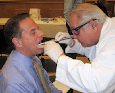Robert Trager, DDS, examines an airline passenger. Image courtesy of the Nassau County Dental Society.