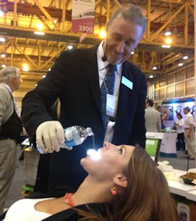 Isolite co-founder Tom Hirsch, DDS, demonstrates how effectively the Isovac enables evacuation with an assistant.