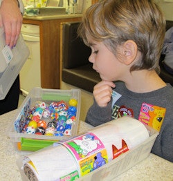Decisions, decisions, decisions. A young boy gets to pick out a prize.