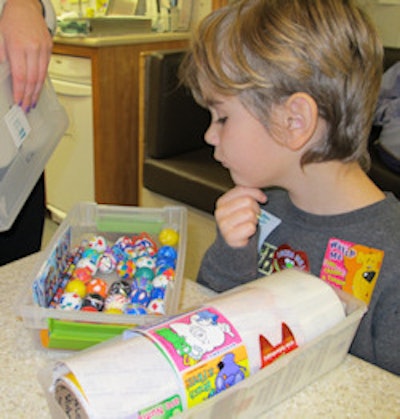 Decisions, decisions, decisions. A young boy gets to pick out a prize.