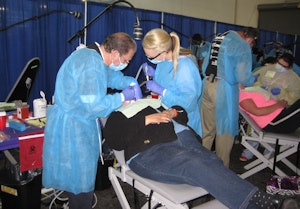Oral and maxillofacial surgeon Alan Felsenfeld, DDS, works on a patient.