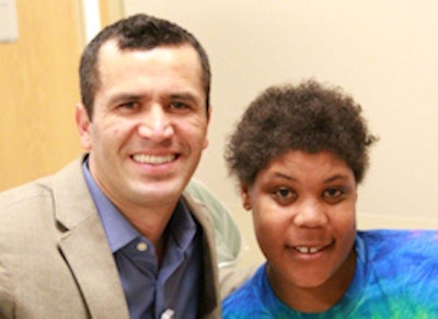 Abrahim Caroci, DMD, a resident at Eastman Institute for Oral Health, with patient Latisha Lucas.