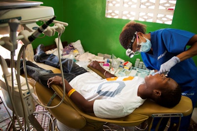 Dr. Schatzie Vincent treats a patient in Haiti. All images courtesy of Aspen Dental.