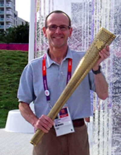 Ian Needleman, BDS, PhD, a professor at University College London, holds the Olympic torch during the London 2012 Olympics.