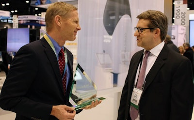 Dentsply Sirona CEO Donald M. Casey Jr. accepts a Dental Excellence Award from DrBicuspid.com CEO Craig Overpeck at the recent Chicago Dental Society 2019 Midwinter Meeting.