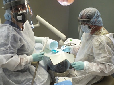 Dr. Warwick and colleague wear protective gear during an amalgam removal procedure. Image courtesy of Dr. David Warwick.