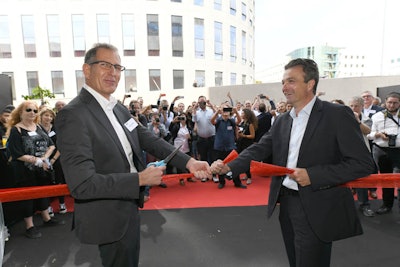 XJet CEO Hanan Gothait (left) and Straumann Vice President Stephan Oehler (right) cut the ribbon at the grand opening of XJet's AM Centre. Image courtesy of XJet.
