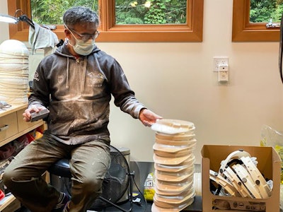 Yamaoka making shields at his garage in Vancouver.