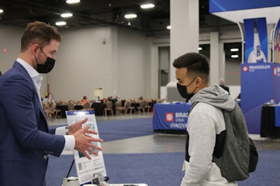 Dr. Matthew Burton speaks with a SmileCon attendee.