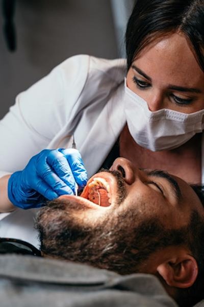 Dr. Deborah Solomon of Smile Health Orthodontics places the Brava appliance on the inside surface of a patient's teeth. Image courtesy of Smile Health Orthodontics.