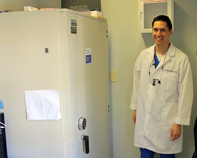 Dr. R. Uilises Melchor pictured with one of the safes that was left behind when he purchased the office space.