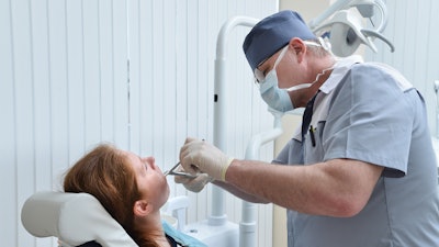 Woman Tooth Extraction Dentist