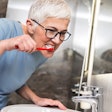 Woman Brushing Teeth Resized
