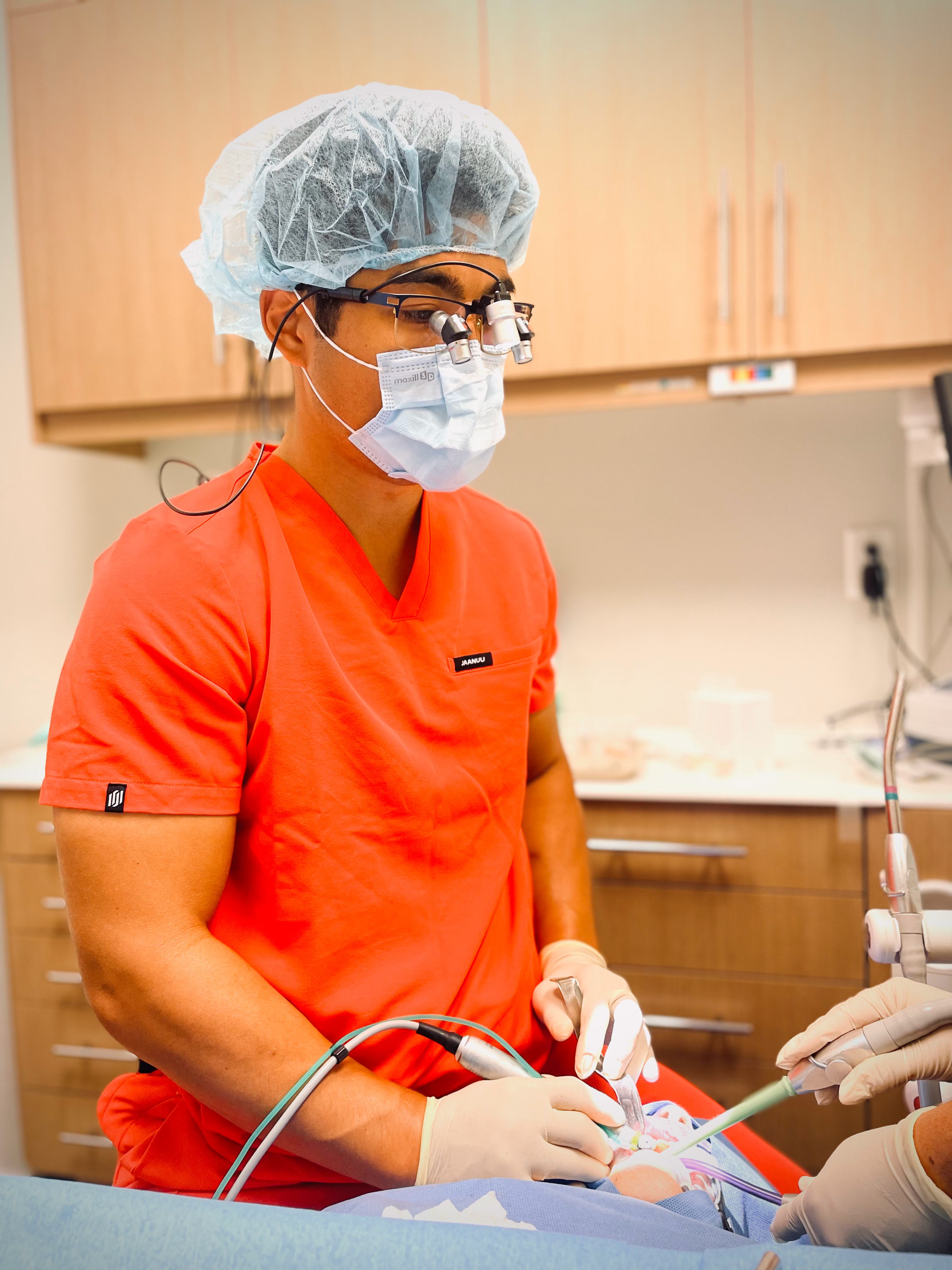 Dr. Chung performing implant surgery. 'Not only is my posture better, but the optics are improved as well,&rdquo; he explained, of using ergonomic loupes. Image courtesy of Dr. Ho-Young Chung.