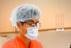 Dr. Chung performing implant surgery. 'Not only is my posture better, but the optics are improved as well,” he explained, of using ergonomic loupes. Image courtesy of Dr. Ho-Young Chung.