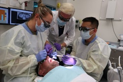 Dr. Robert H. Gregg II, founder, president, and chairman of the board at Millennium Dental Technologies, oversees the LANAP protocol on a patient at the U.S. Air Force Postgraduate Dental School. Image and caption courtesy of Millenium Dental Technologies.