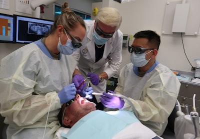 Dr. Robert H. Gregg II, founder, president, and chairman of the board at Millennium Dental Technologies, oversees the LANAP protocol on a patient at the U.S. Air Force Postgraduate Dental School. Image and caption courtesy of Millenium Dental Technologies.