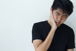 Young Man Holding Jaw