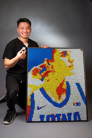 Brian Dang pictured next to his Rubik's Cube creation. Image courtesy of Brian Dang.