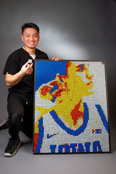 Brian Dang pictured next to his Rubik's Cube creation. Image courtesy of Brian Dang.