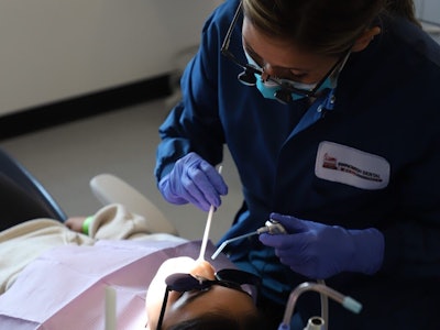 Dental therapist Sarah Chagnon treats a patient at the Swinomish Dental Clinic in La Conner, WA, as part of a school-based 'sealant week' program. More states are considering authorizing licensures of dental health aide therapists, also known as dental therapists. Experts say the midlevel practitioners can help fill gaps in access to dental health care. Image courtesy of Swinomish Dental Clinic.