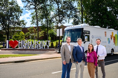 The PDS Foundation donated its mobile dental clinic to the High Point University Workman School of Dental Medicine on July 23, 2024. Pictured (left to right): Dr. Kevin Cain, senior associate dean for administration and finance, the Workman School of Dental Medicine; Michael Le, executive director, the PDS Foundation; Dr. Johanna Tesoniero, associate dean for clinical operations, the Workman School of Dental Medicine; Jeffrey Lewallen, manager of strategic initiatives, the Workman School of Dental Medicine. Image and caption courtesy of the PDS Foundation.