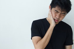 Young Man Holding Jaw