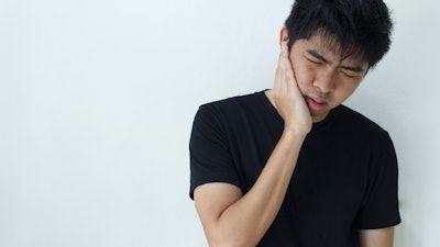 Young Man Holding Jaw