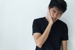 Young Man Holding Jaw