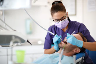 Woman Dentist Male Patient Luckybusiness