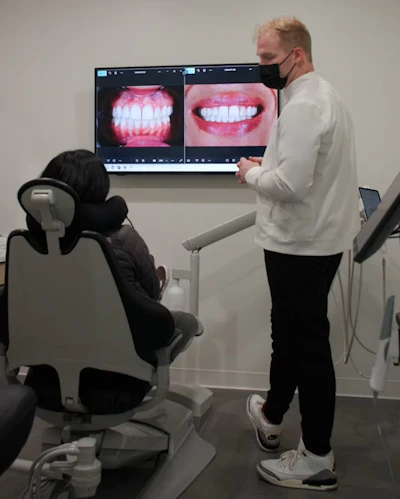 Dr. Kooper Ruminer discusses smile options with a patient.