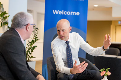 Dr. Jan Derks (right) told Kevin Henry (left) that dentists offering -- or considering offering -- implant therapy should have a plan in place for combating peri-implantitis.