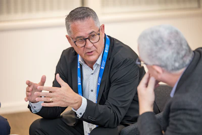 Aldo Denti (left) answers questions from DrBicuspid.com's Editor-in-Chief Kevin Henry (right).