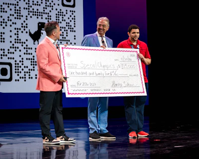 Special Olympics' Chief Health Officer Dr. Dimitri Christakis (center) and Special Olympics Nevada athlete Paul Brooks Jr. (right) at the Thrive Live conference in Las Vegas, where Henry Schein renewed its partnership with Special Olympics.