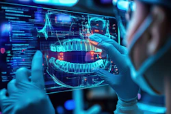 A dentist wearing personal protective equipment looks at a holographic image of a panoramic x-ray.