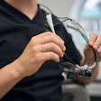 Close-up of a male dentist preparing to put on loupes.
