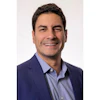 Headshot of Miguel Oliveira, senior vice president of omnichannel experience at the Aspen Group.