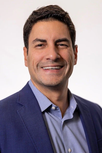 Headshot of Miguel Oliveira, senior vice president of omnichannel experience at the Aspen Group.